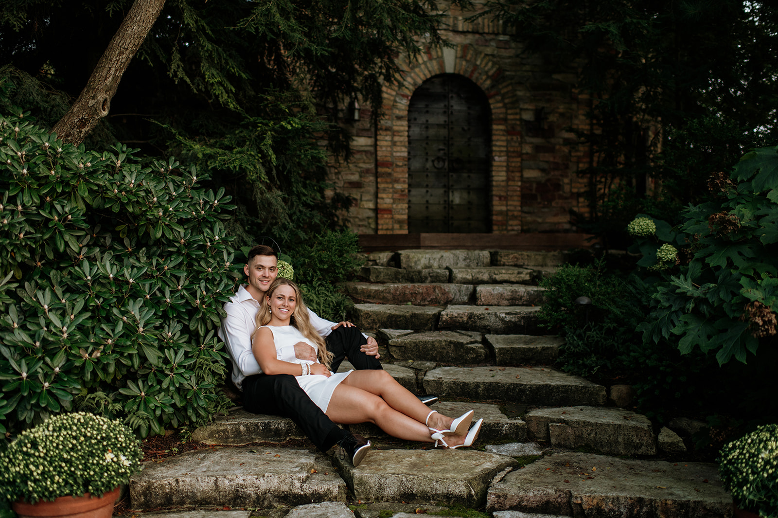 Couple sitting on steps during their Indiana engagement session