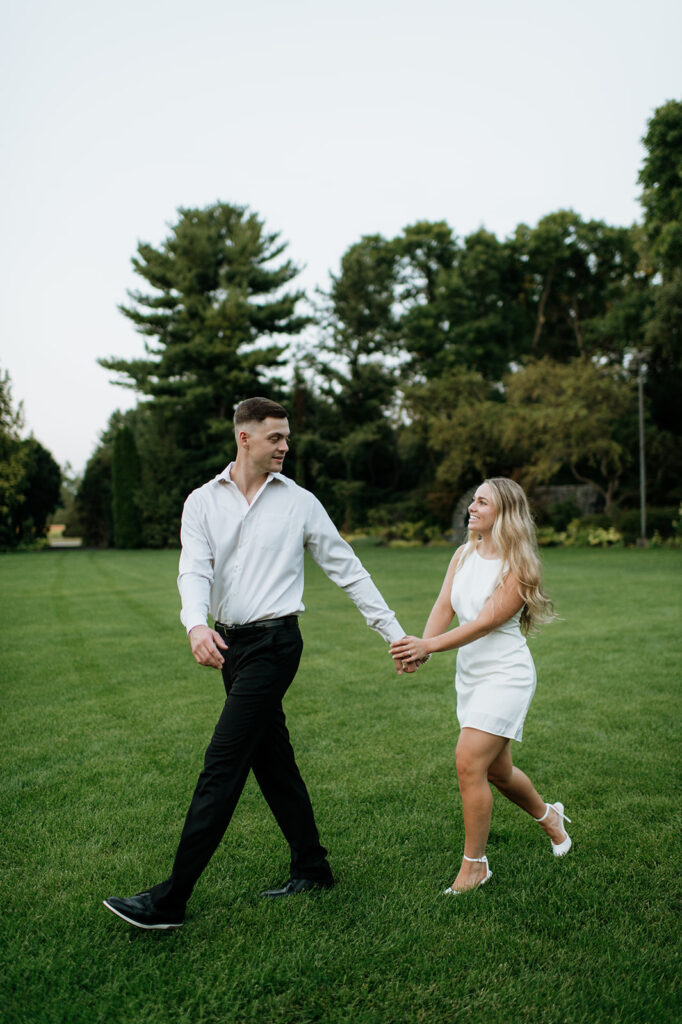 Couple walking the grounds of Hamstra Gardens in Wheatfield, Indiana for their engagement shoot