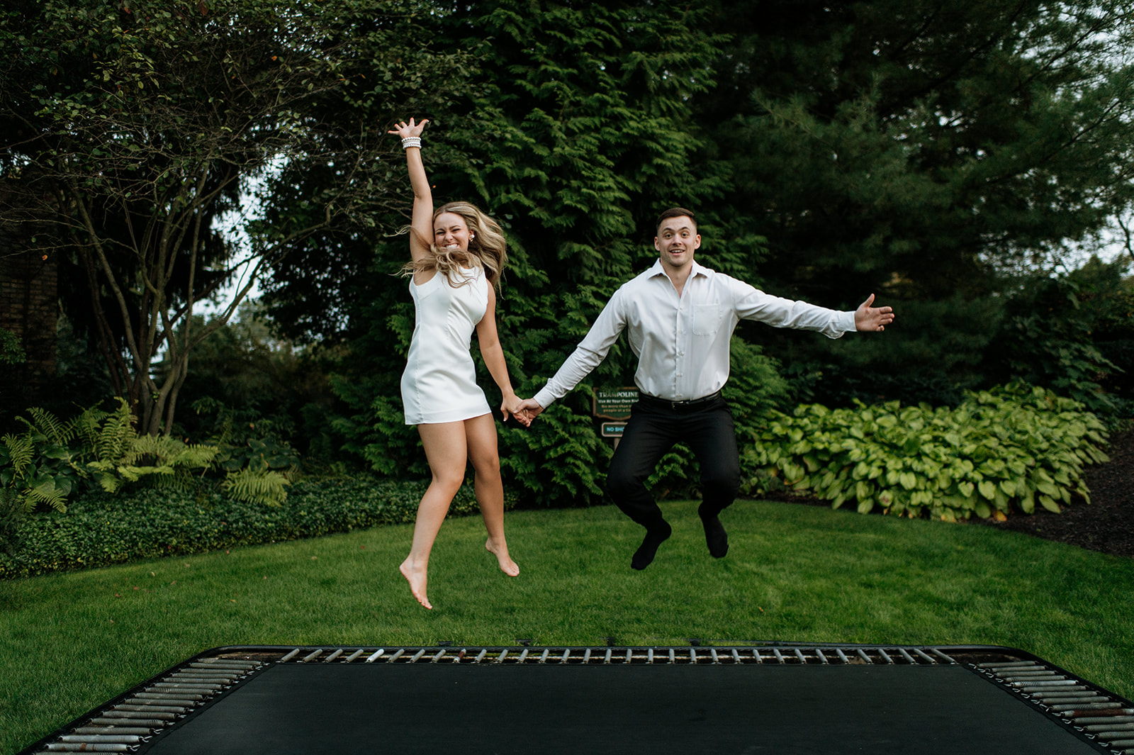 Couple jumping on a trampoline together at Hamstra Gardens in Wheatfield, Indiana