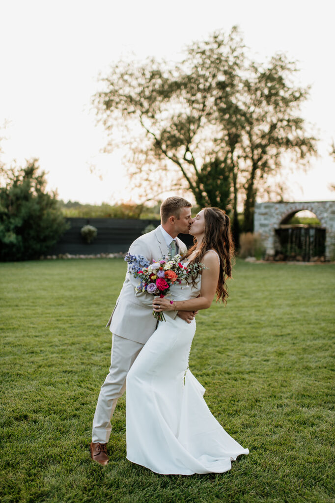 Bride and groom kissing during their outdoor portraits from their Empeiria 110 wedding in Rochester, Indiana