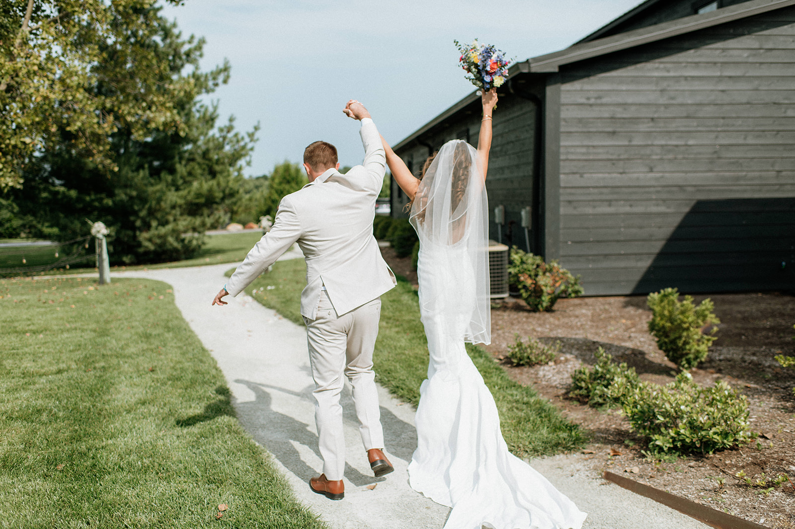 Bride and groom celebrating with their arms in the air after their ceremony