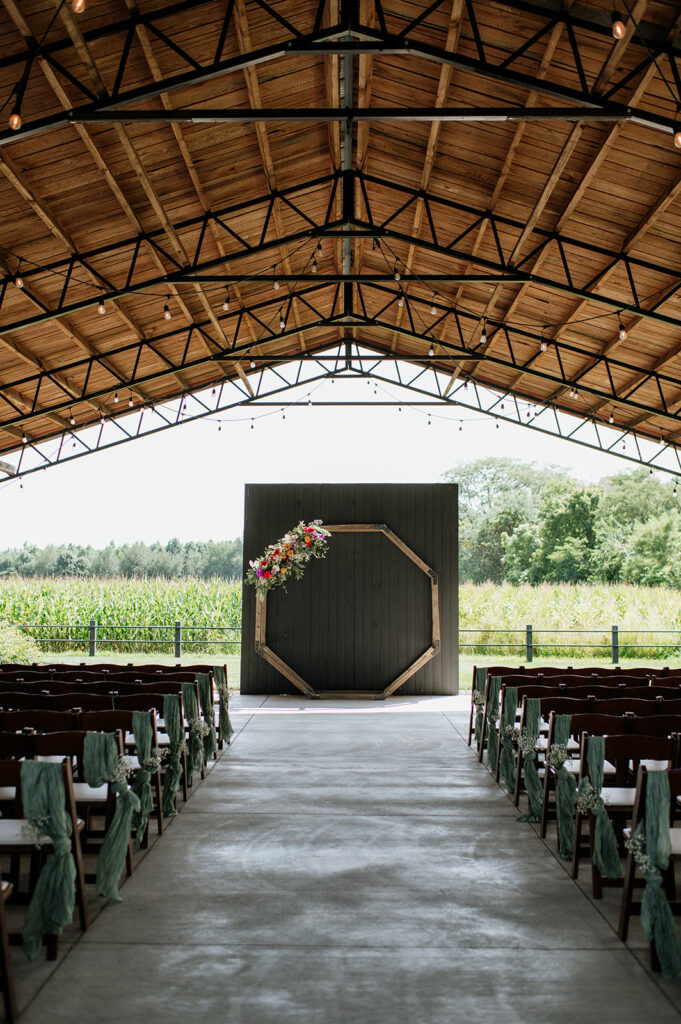 An outdoor Empeiria 110 wedding ceremony underneath the pavilion 