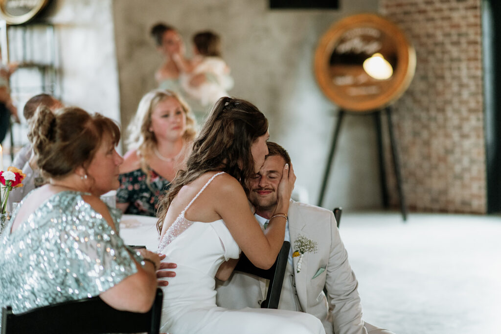 Bride kissing the groom on his forehead