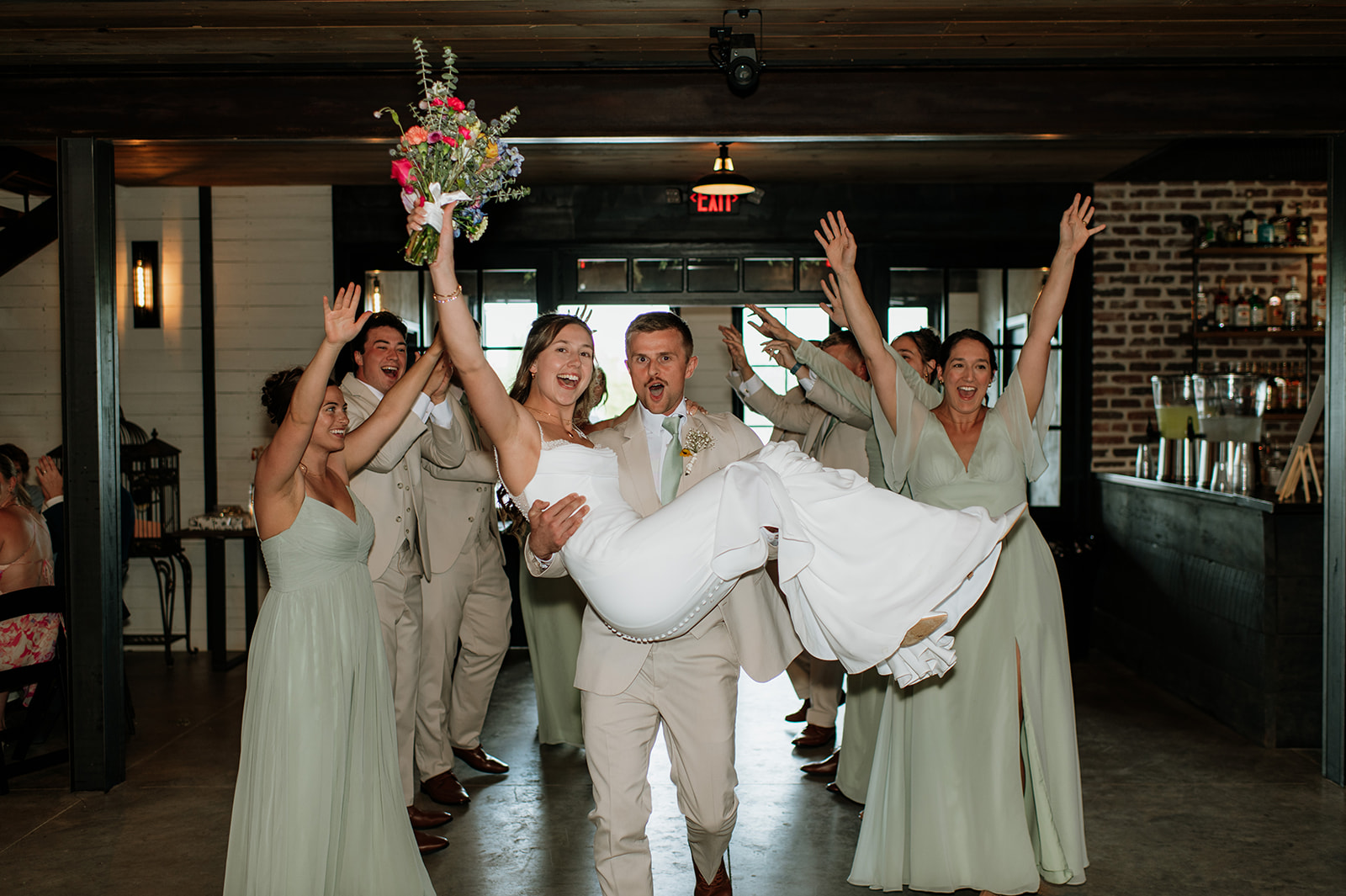 Bride and groom entering their wedding reception