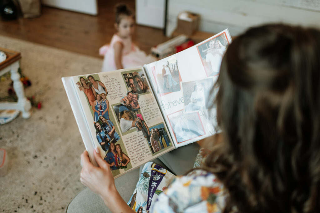 Bride reading the scrapbook her bridesmaids got her