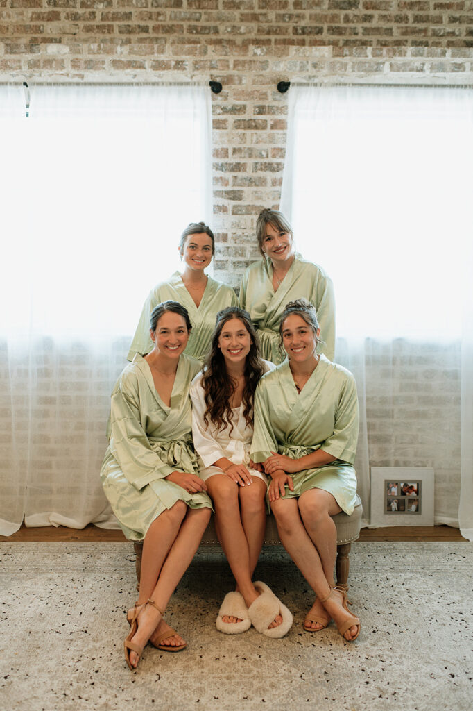 Bride and bridesmaids posing in their matching robes