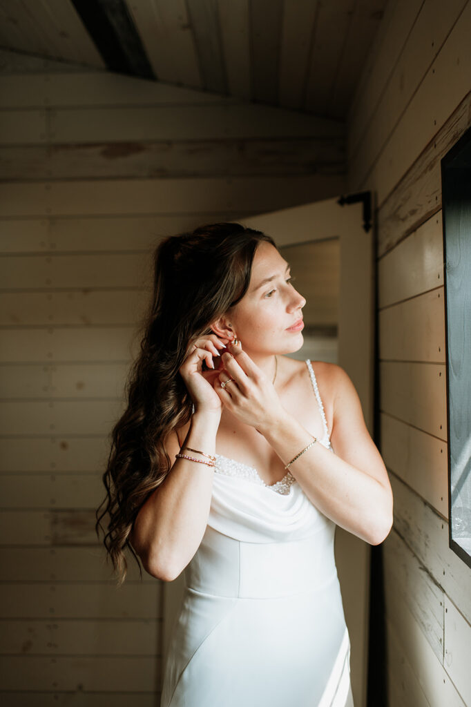 Bride putting her earrings in