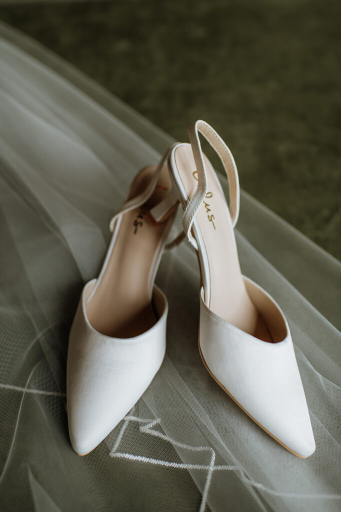 Brides heels posed on her wedding veil