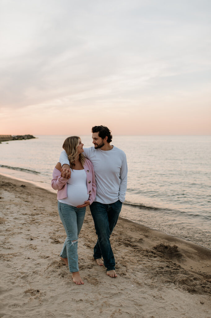 Couple walking alone the shoreline at New Buffalo Beach