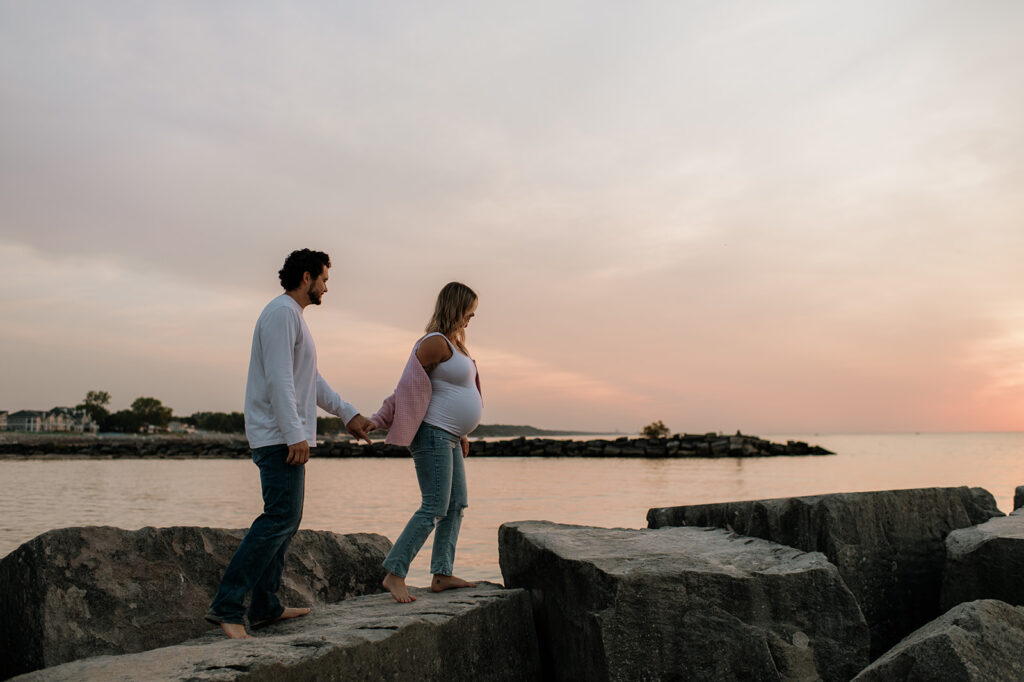 Couple walking along the beach rocks at New Buffalo Michigan