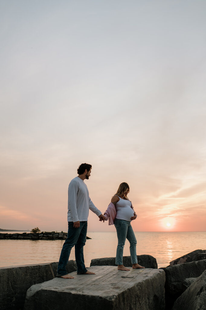 Couple walking along the beach rocks at New Buffalo Michigan