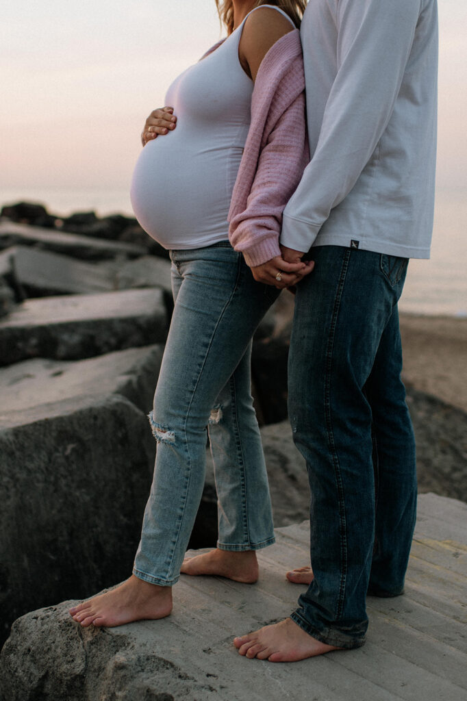 Close up shot of a couples maternity shoot at sunset