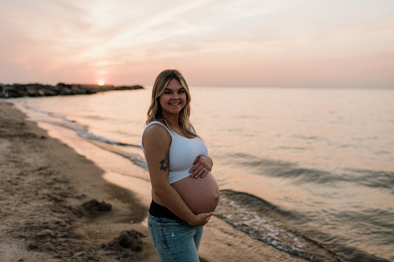 Pregnant woman holding her belly at New Buffalo Michigan