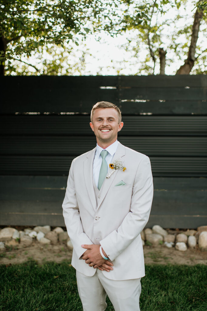 Grooms outdoor portraits during a summer Empeiria 110 wedding in Rochester, Indiana