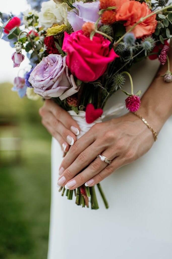 Bride holding her colorful summer wedding bouquet