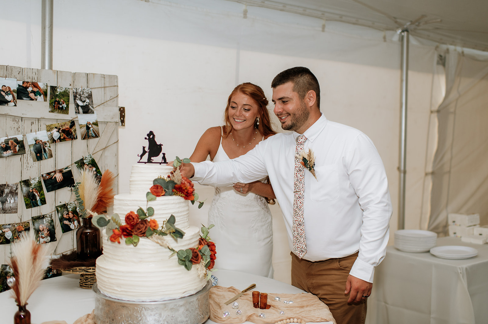 Bride and groom cutting into their cake