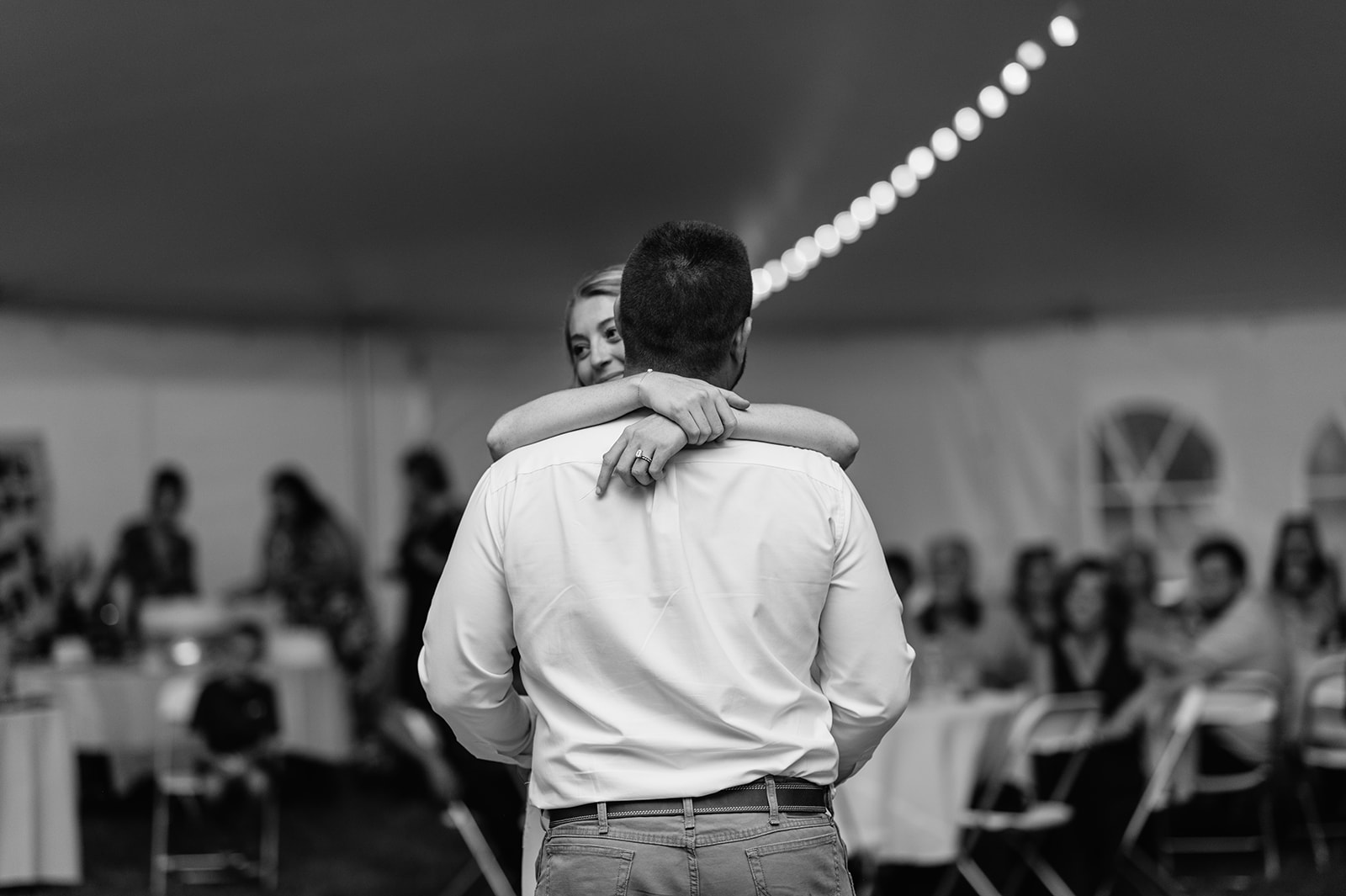 Black and white photo of a bride and groom sharing their first dance