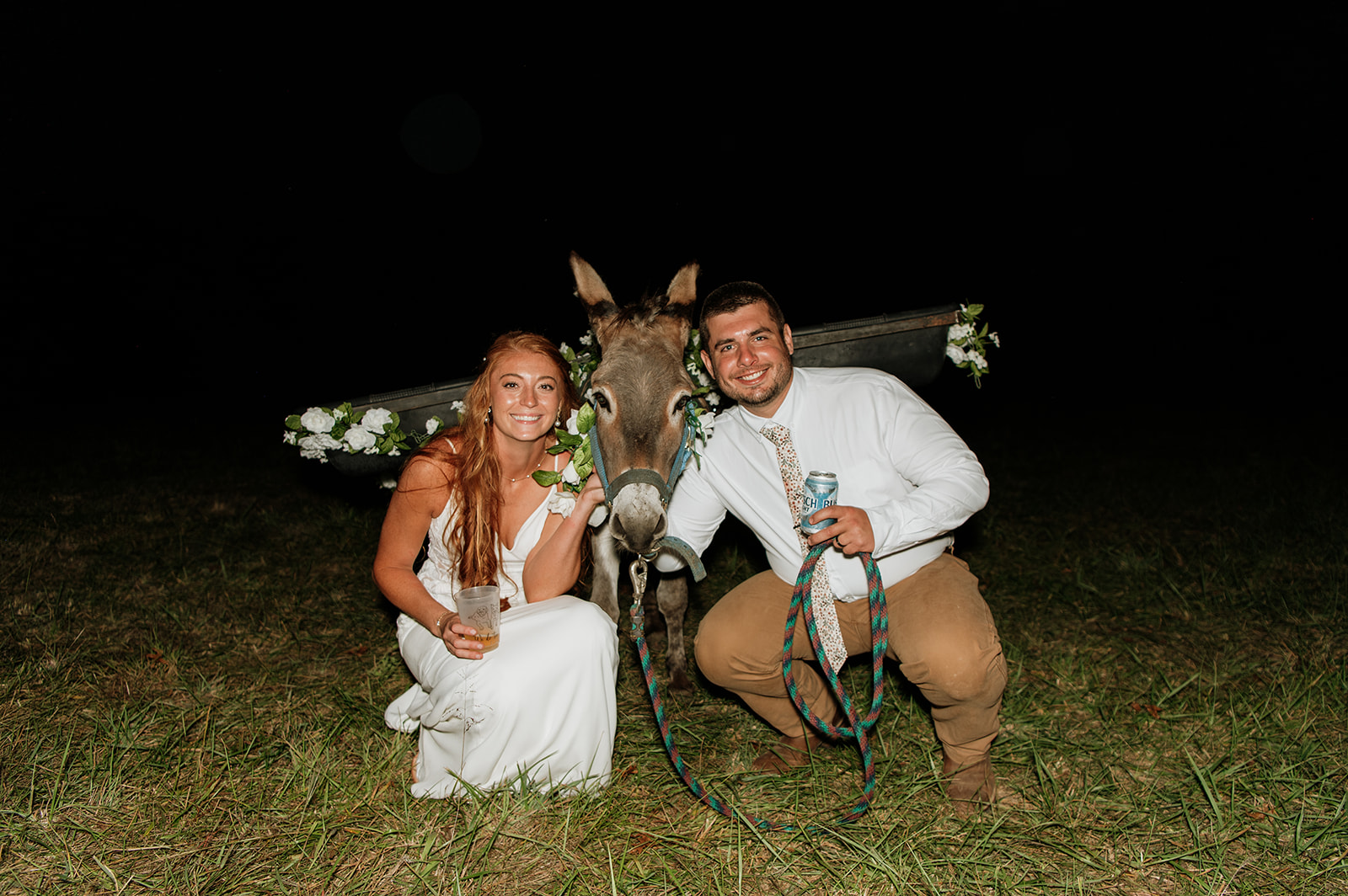 Bride and groom posing with a beer donkey