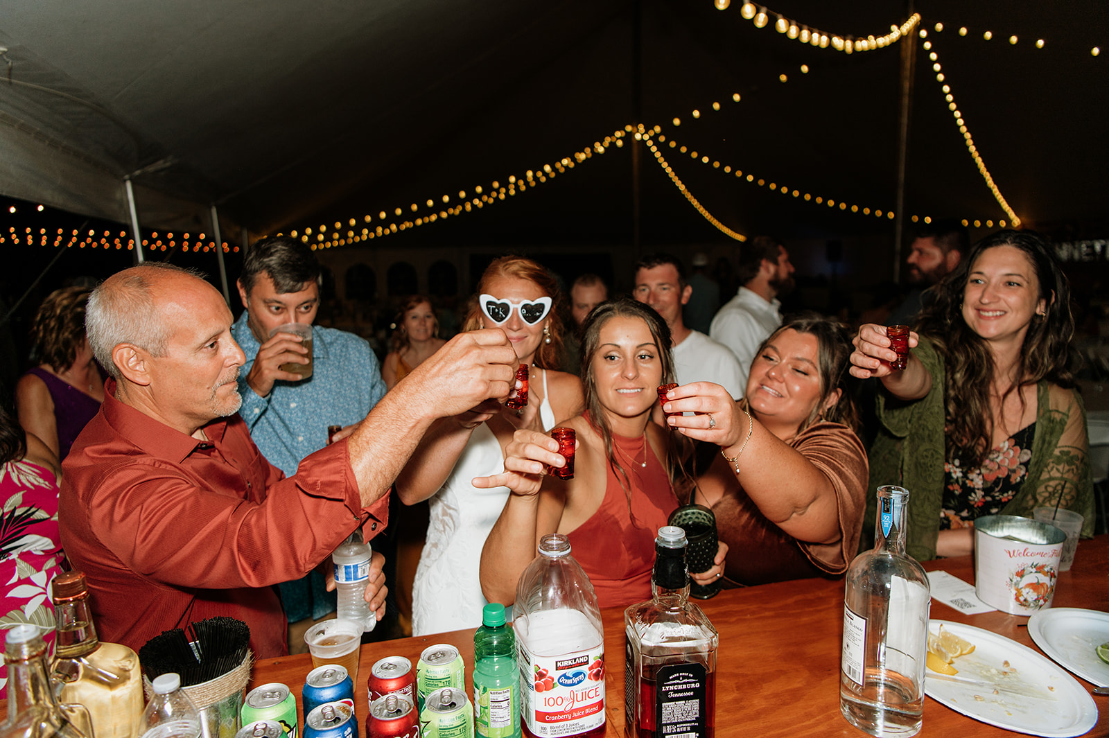 Bride taking a shot with guests