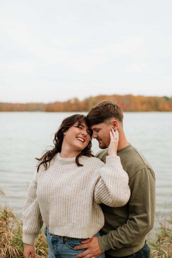 Couple posing in front of Worster Lake at Potato Creek State Park