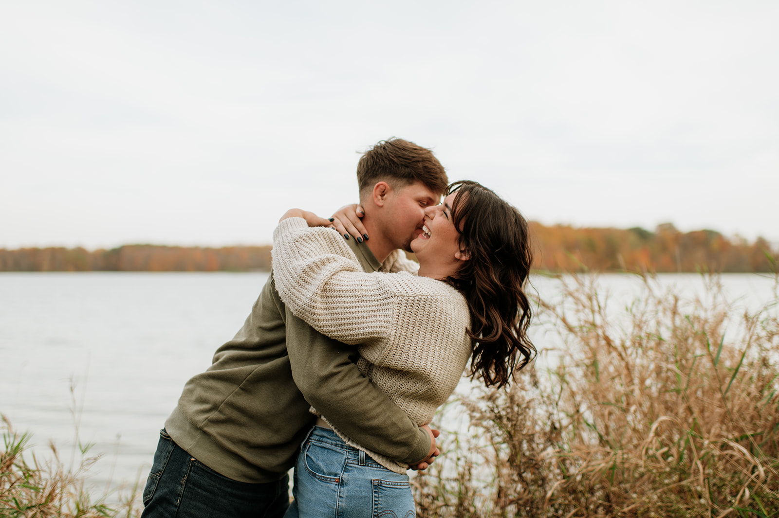 Man and woman being playful during their Northern Indiana engagement photos at Potato Creek State Park