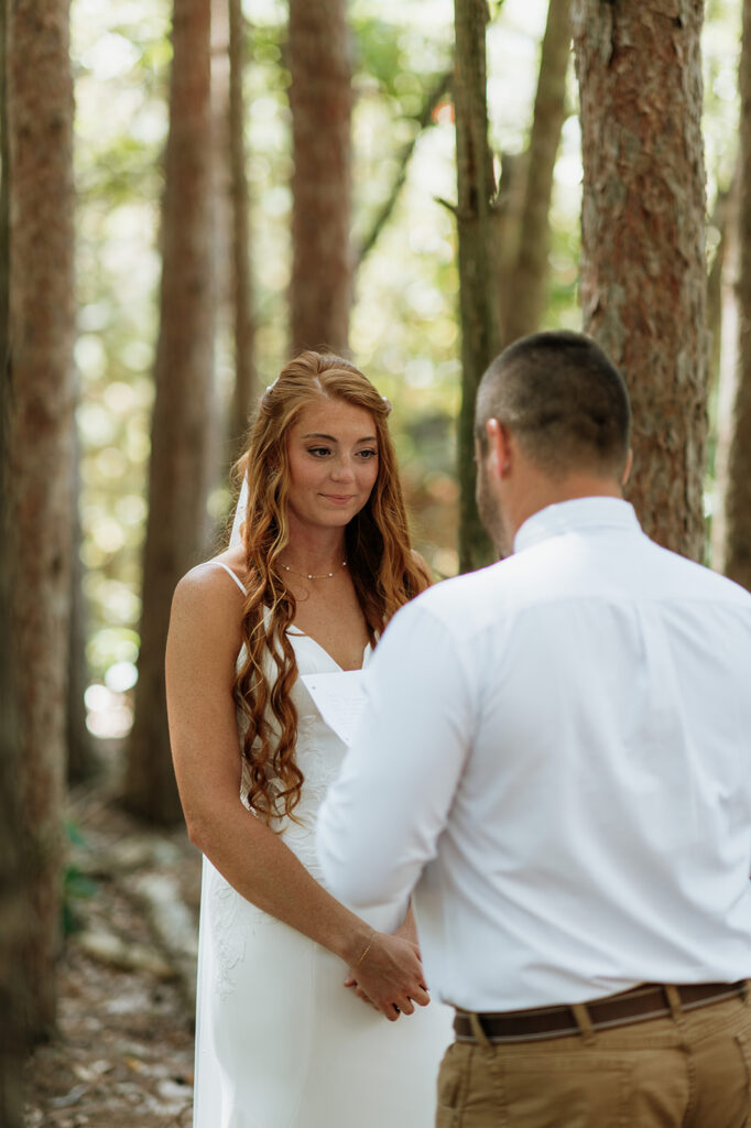 Groom reading his vows to his bride during their first look