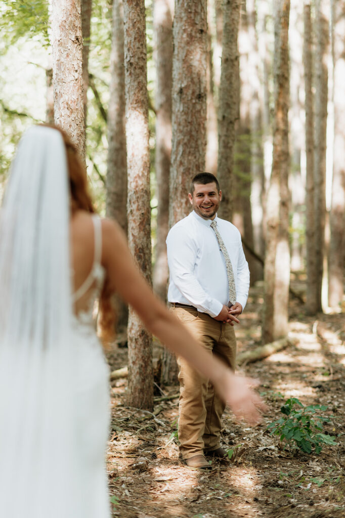 Groom seeing his bride during their first look for their Bride and groom about to share a first look for their fall backyard wedding in Culver, Indiana