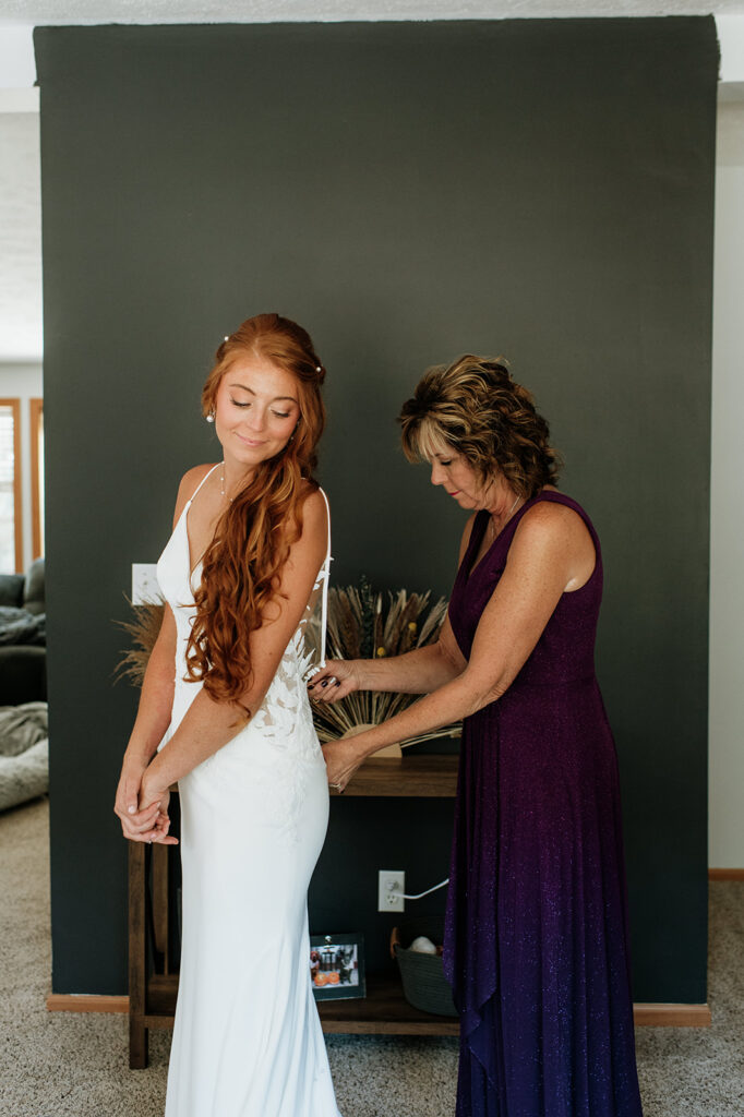 Bride getting her dress zipped up