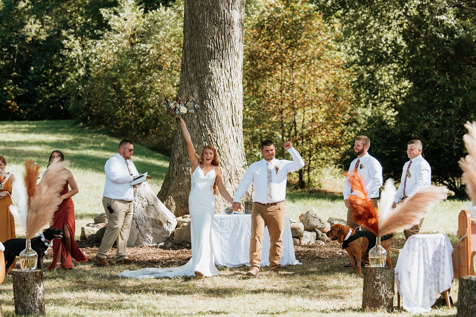 Bride and groom celebrating after their fall backyard wedding ceremony