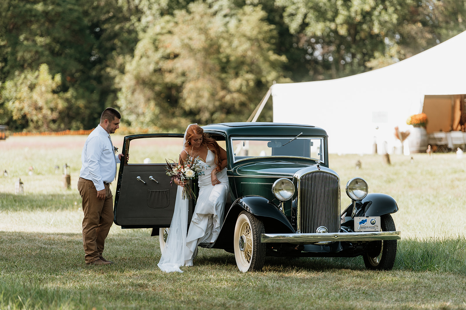 Bride and groom entering their vintage car after their ceremony