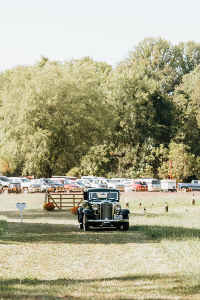 Bride arriving in a vintage green car