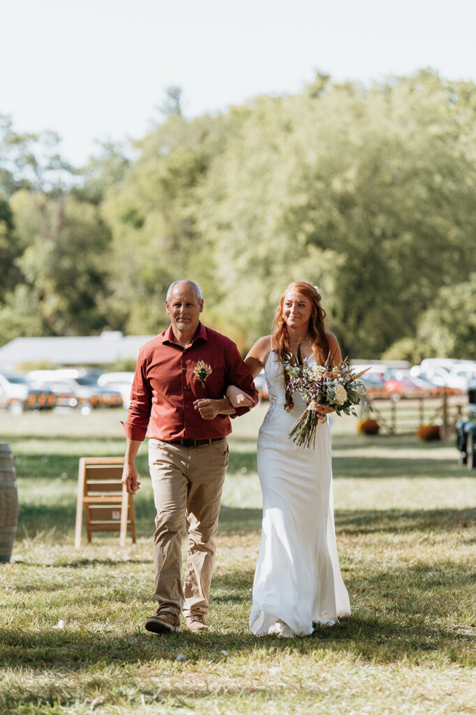 Bride being walked down the aisle by her father