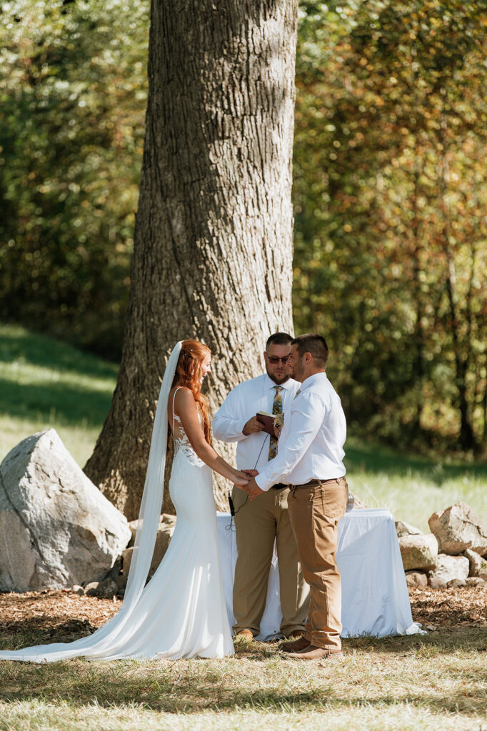 Bride and groom holding hands during their wedding ceremony