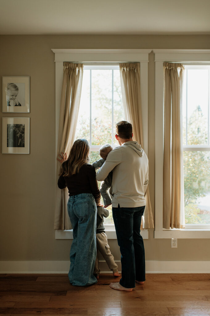 Family of four looking out their window for their at-home Northern Indiana family photos