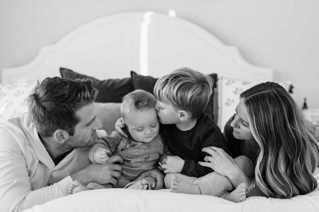 Black and white photo of a family of four posing for their at-home Northern Indiana family photos