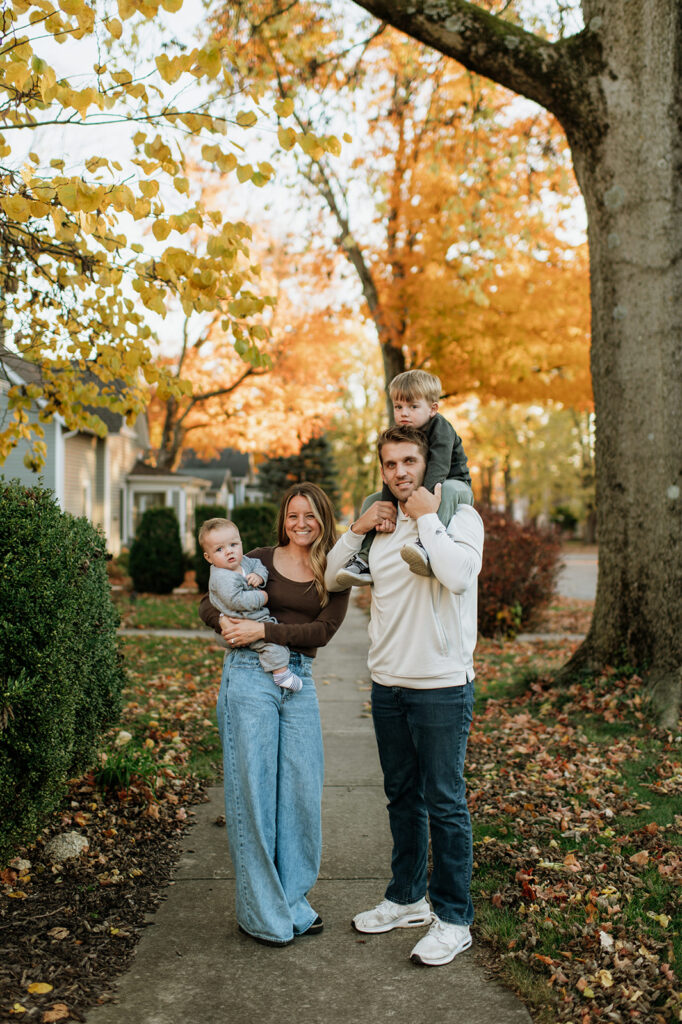 Family of four walking down their street for their Northern Indiana family photos