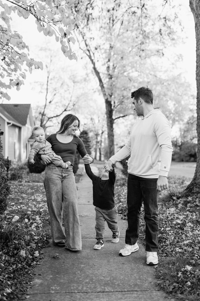 Family of four walking down their street for their Northern Indiana family photos