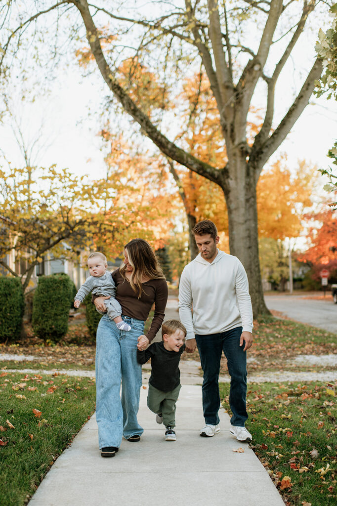 Family of four walking down their street during their Northern Indiana family photos