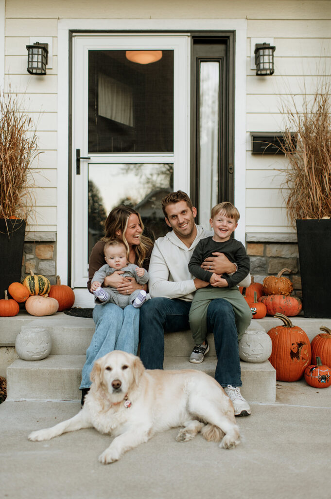 Family of four posing on their steps outside during their at-home Northern Indiana family photos