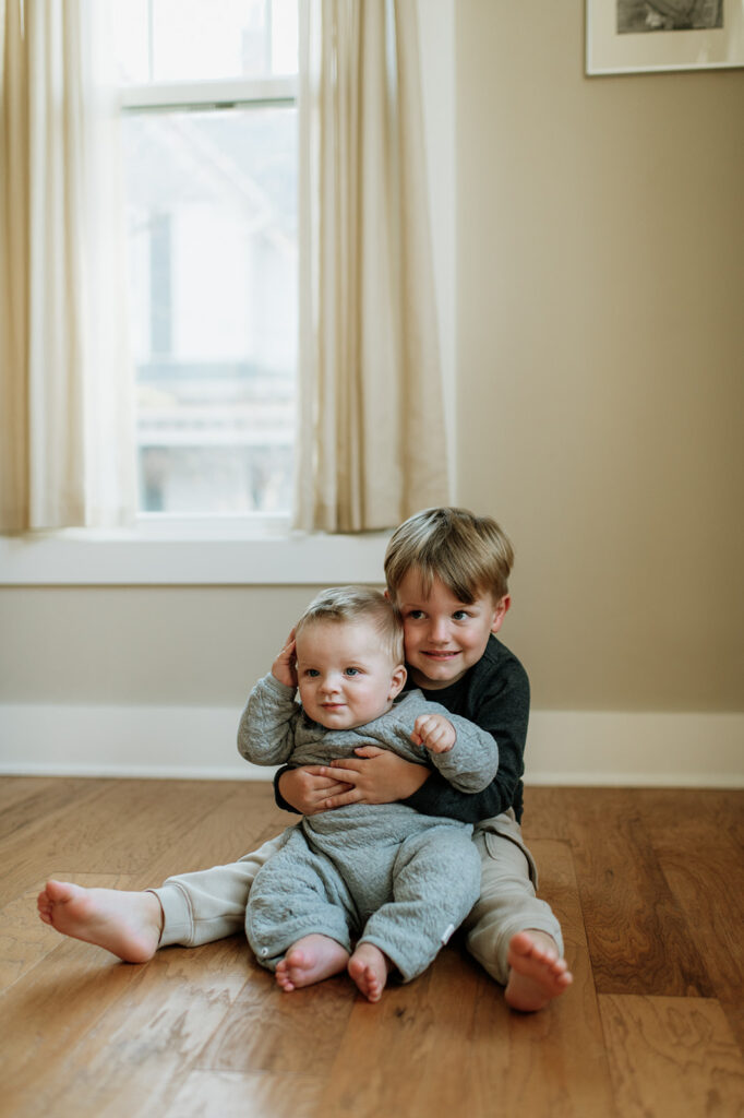 Big and little brother posing for their at-home Northern Indiana family photos