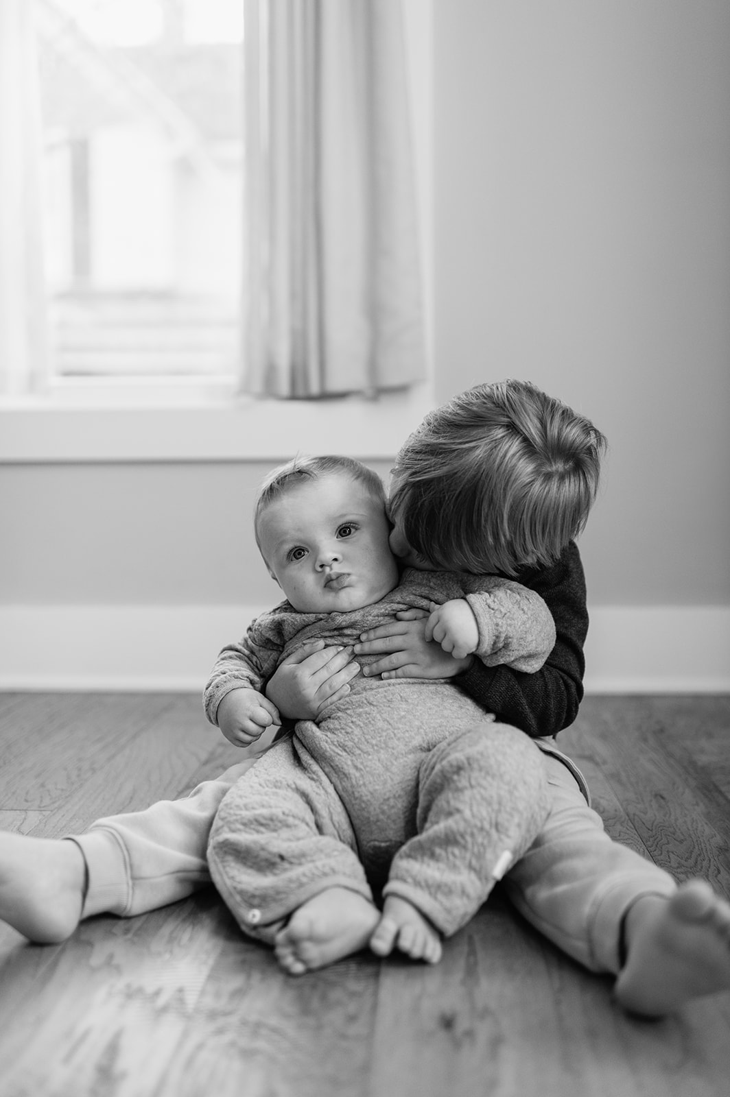 Big and little brother posing for their at-home Northern Indiana family photos