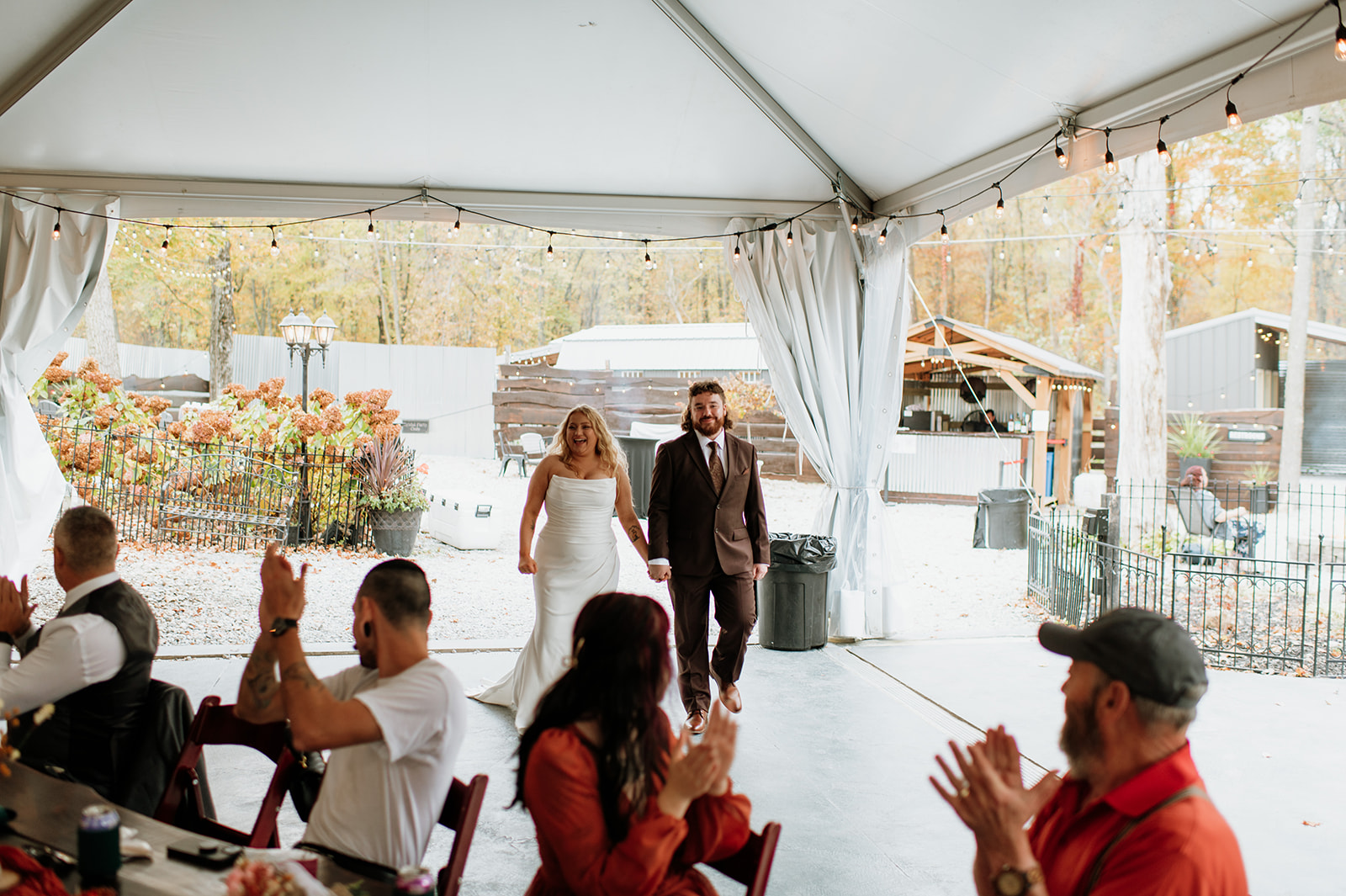 Bride and groom entering their reception