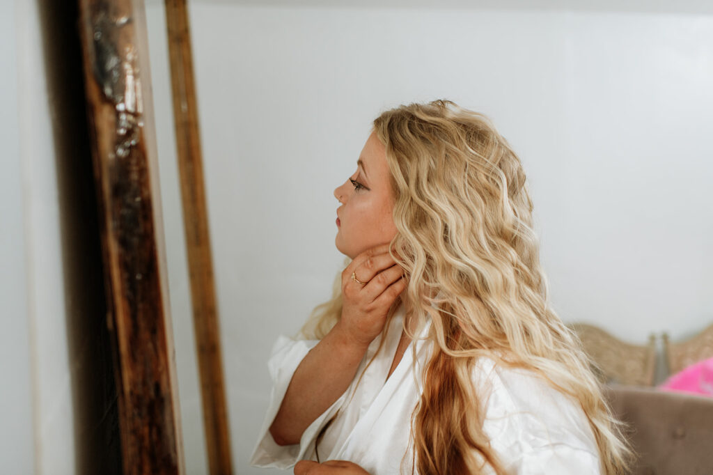 Bride putting her earrings in