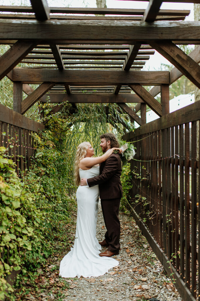 Bride and grooms portraits at Willow Acres wedding venue at their "wedding wall"