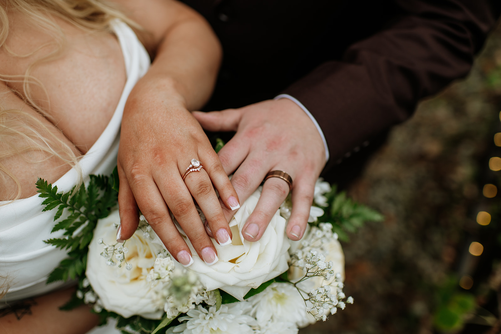 Bride and groom showing off their wedding rings