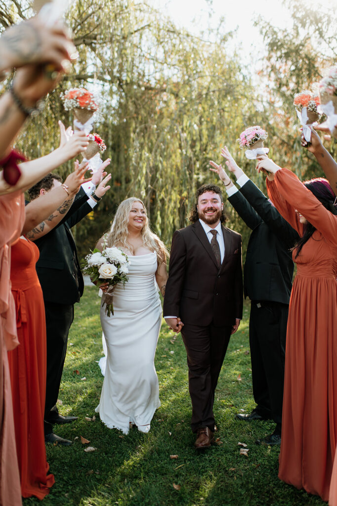 Bride and groom posing with their wedding party during their Willow Acres wedding in Middletown, Indiana