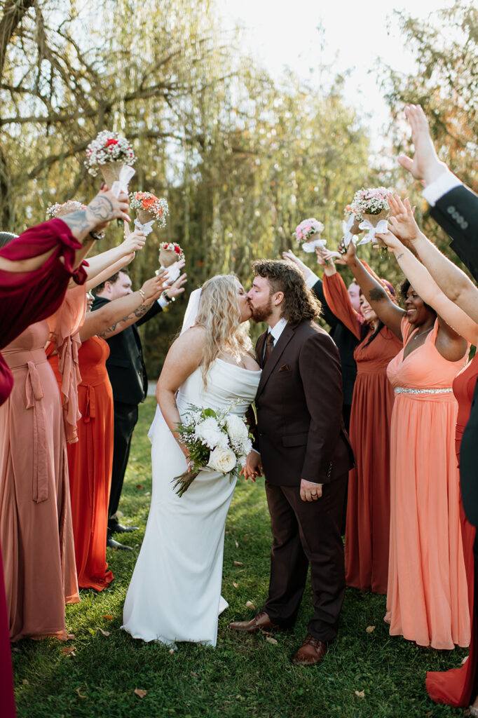 Bride and groom posing with their wedding party during their Willow Acres wedding in Middletown, Indiana