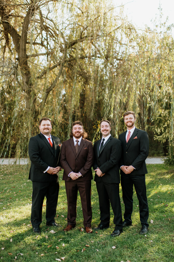 Outdoor groom and groomsmen portraits from a Willow Acres wedding in Middletown, Indiana