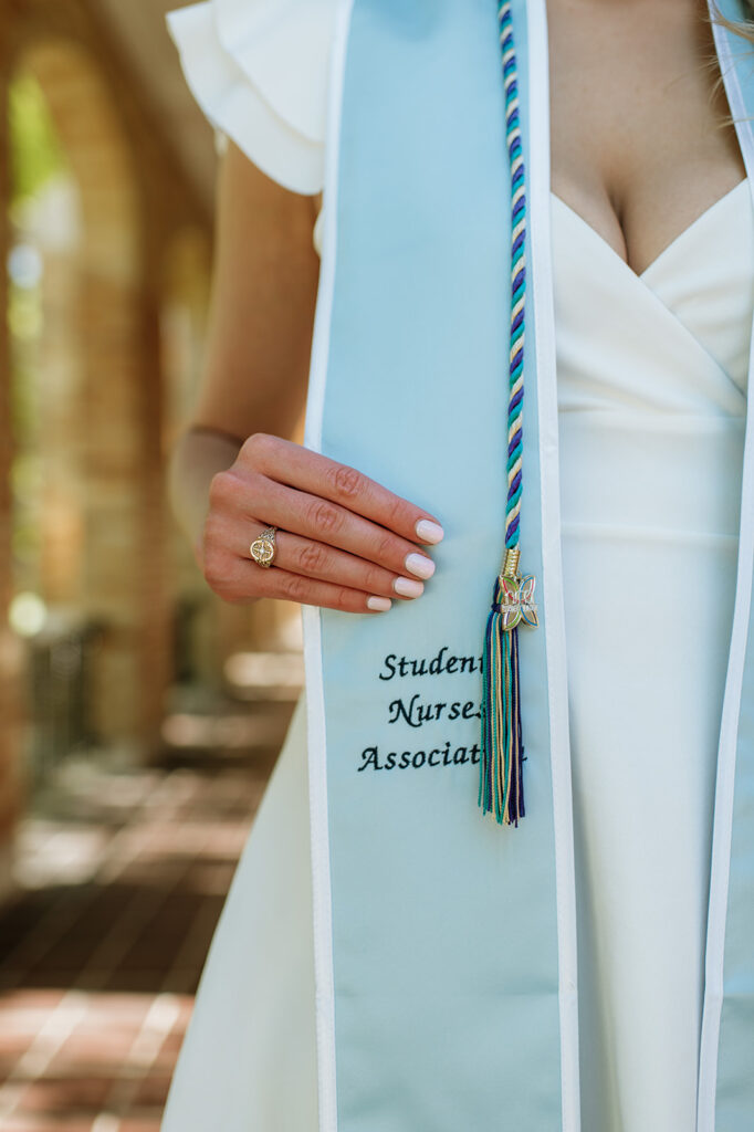 Graduate showing off her student nurse attire during her grad shoot