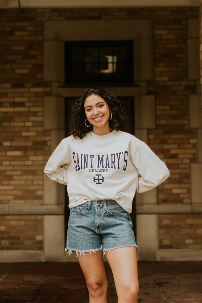 Girl posing in her graduation shirt for photos